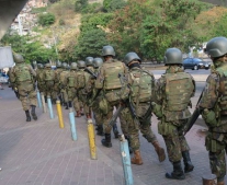 Exército brasileiro caminha em fila única pelas ruas do morro da Rocinha